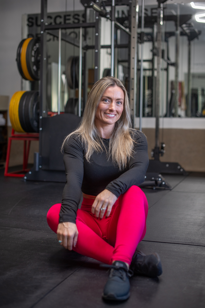 The coach is smiling while seating.